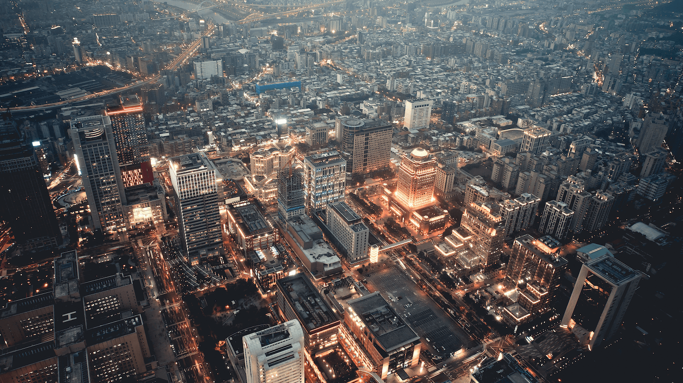 Urban city at sunset. Glowing lines make connections between buildings.